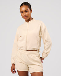 Woman wearing CloudWaffle Midi Zip Up - Vanilla Bean | Model:Jordan | Size:XS | Thumbnail Index: 0