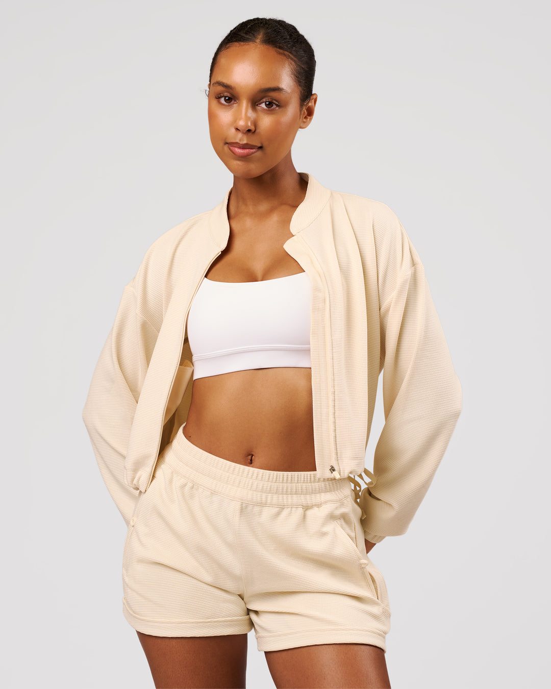 Woman wearing CloudWaffle Midi Zip Up - Vanilla Bean | Model:Jordan | Size:XS - view 2