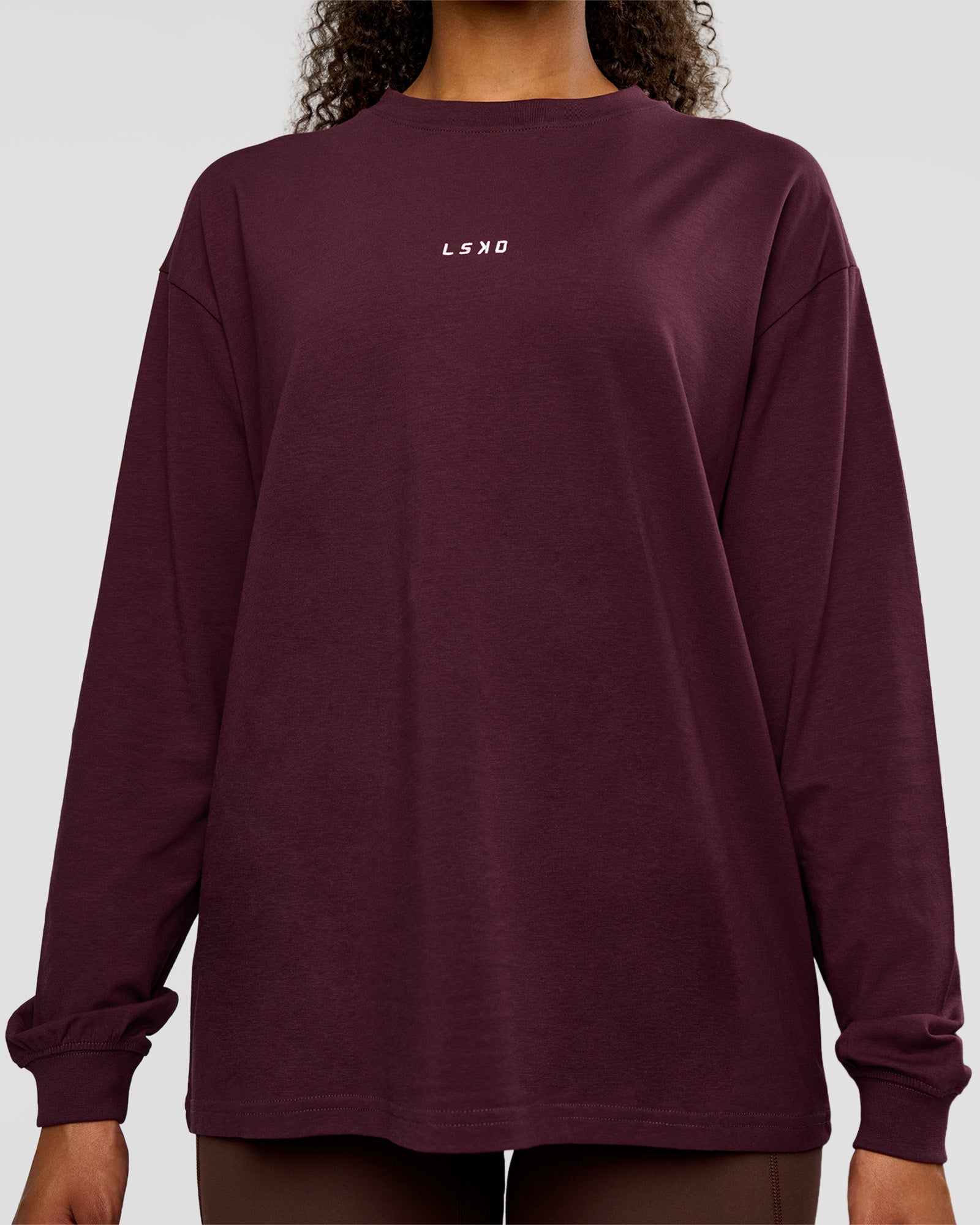 Woman wearing Go-To Long Sleeve FLXCotton Oversized Tee - Cherry Lacquer-White | Model:Jordan | Size:XS