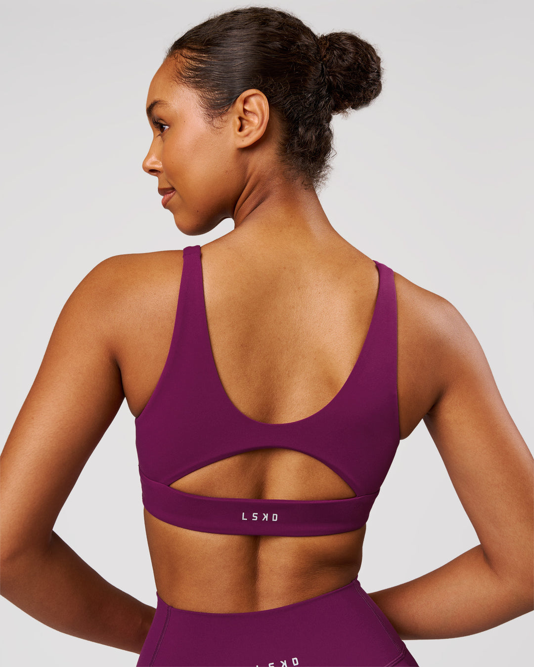 Woman wearing Vitality Sports Bra - Plum Caspia | Model:Jordan | Size:XS - view 2