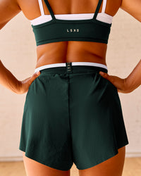 Woman wearing Trackline Accelerate 3" High-Rise Running Short - Midnight Green-White | Model:Meg | Size:XS | Thumbnail Index: 3