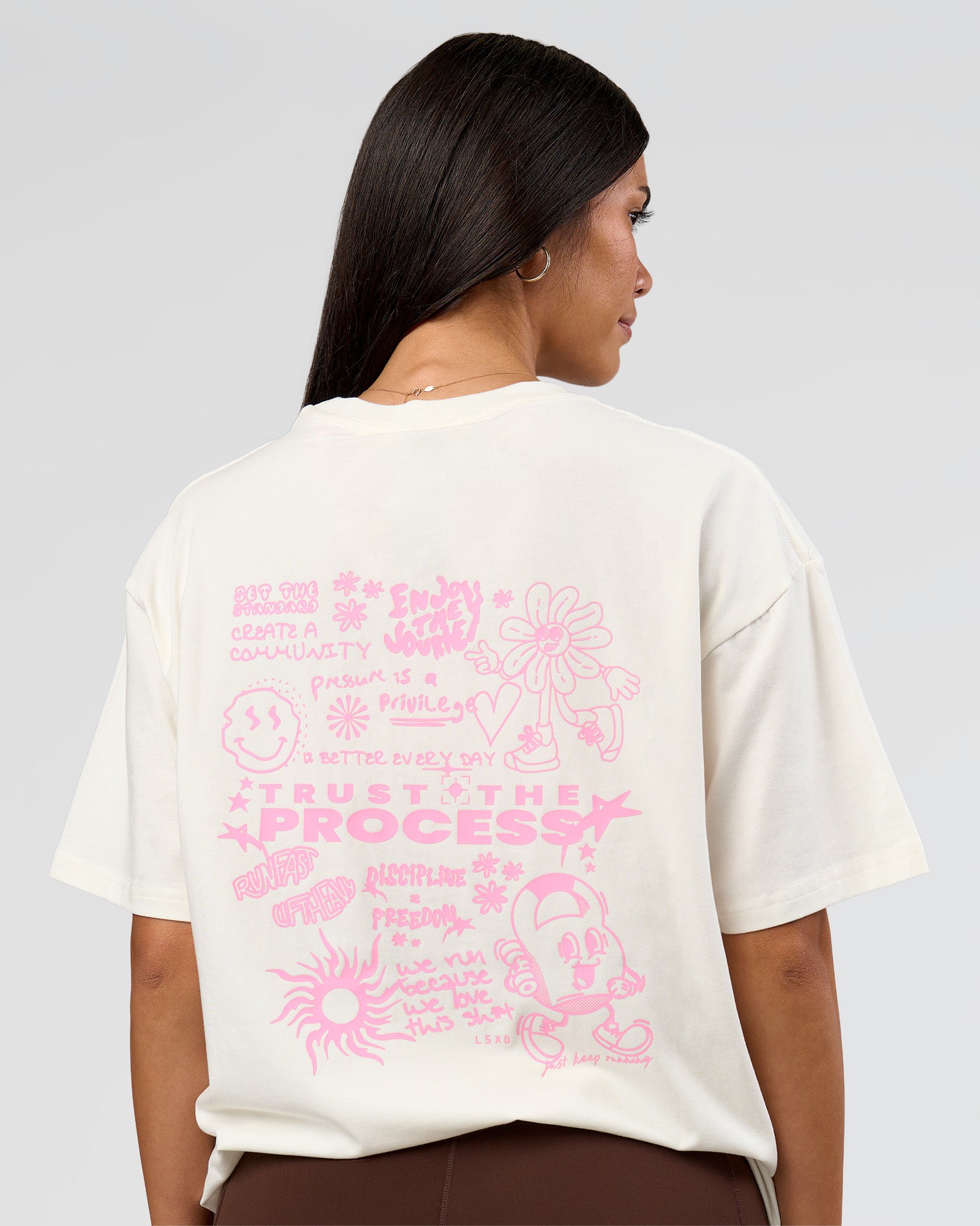 Woman wearing Built On Values FLXCotton Oversized Tee - Off White-Pink Rose | Model:Rhiley | Size:XS