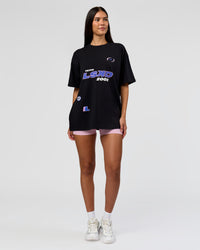 Woman wearing League Heavyweight FLXCotton Oversized Tee - Black-Power Cobalt | Model:Rhiley | Size:XS