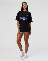 Woman wearing League Heavyweight FLXCotton Oversized Tee - Black-Power Cobalt | Model:Rhiley | Size:XS
