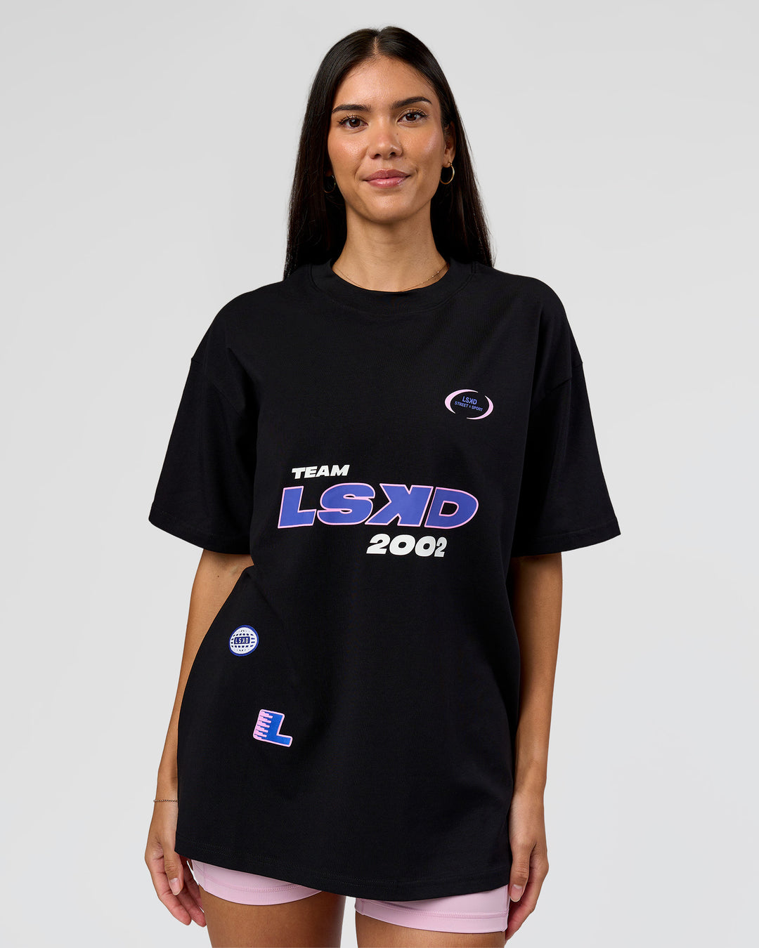 Woman wearing League Heavyweight FLXCotton Oversized Tee - Black-Power Cobalt | Model:Rhiley | Size:XS