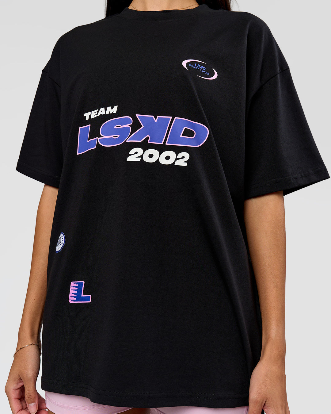Woman wearing League Heavyweight FLXCotton Oversized Tee - Black-Power Cobalt | Model:Rhiley | Size:XS