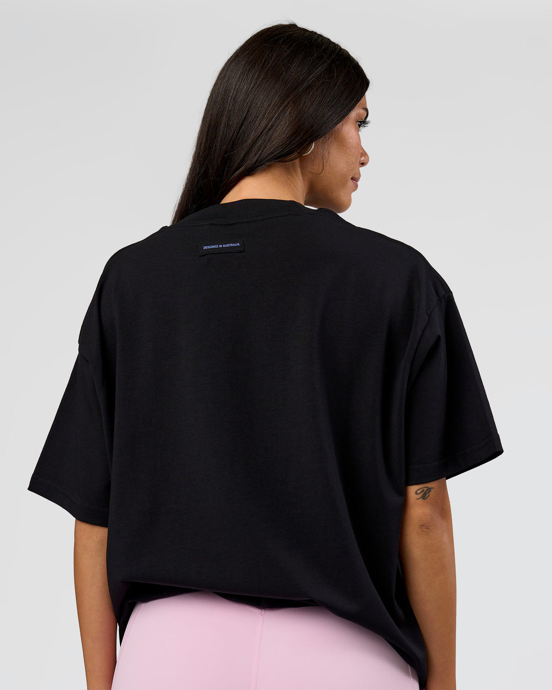 Woman wearing League Heavyweight FLXCotton Oversized Tee - Black-Power Cobalt | Model:Rhiley | Size:XS