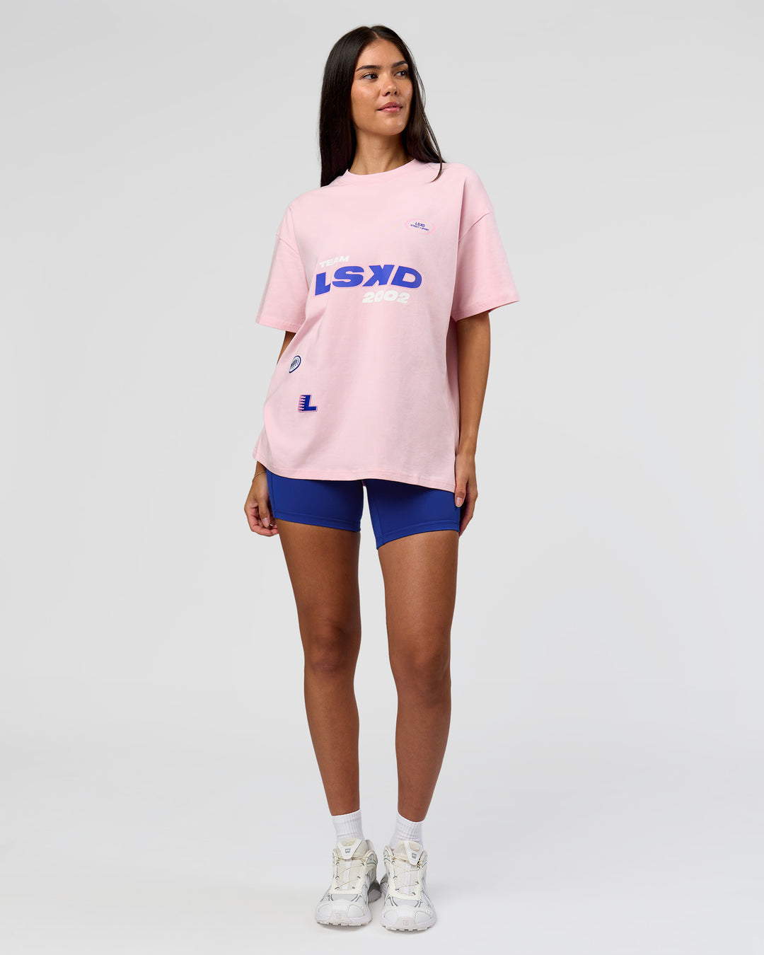 Woman wearing League Heavyweight FLXCotton Oversized Tee - Marshmallow-Power Cobalt | Model:Rhiley | Size:XS