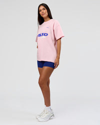 Woman wearing League Heavyweight FLXCotton Oversized Tee - Marshmallow-Power Cobalt | Model:Rhiley | Size:XS