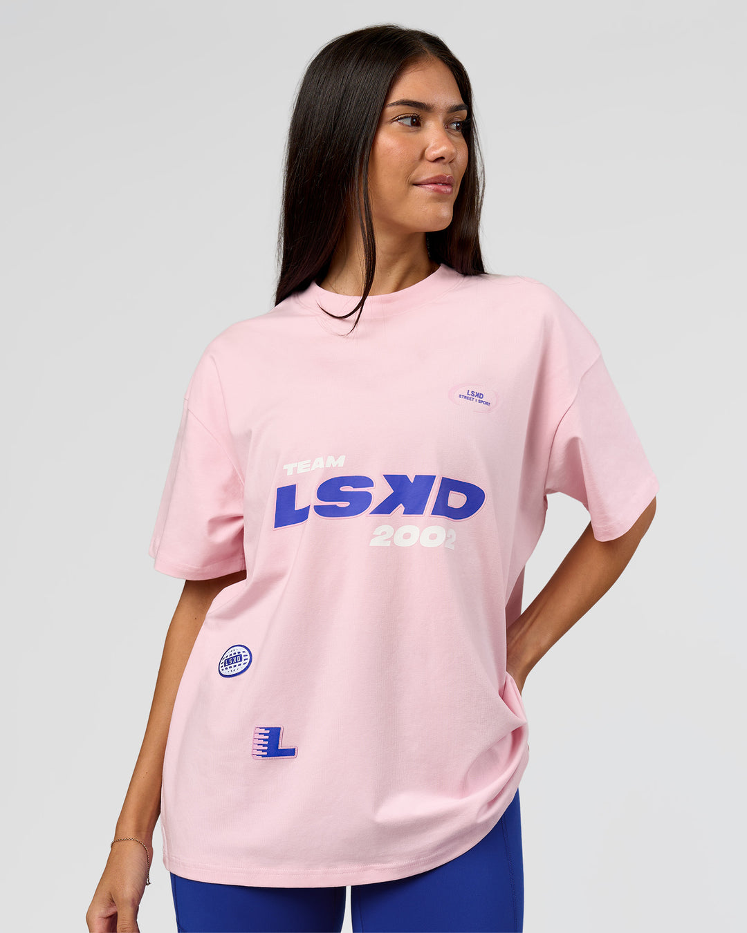 Woman wearing League Heavyweight FLXCotton Oversized Tee - Marshmallow-Power Cobalt | Model:Rhiley | Size:XS