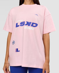 Woman wearing League Heavyweight FLXCotton Oversized Tee - Marshmallow-Power Cobalt | Model:Rhiley | Size:XS