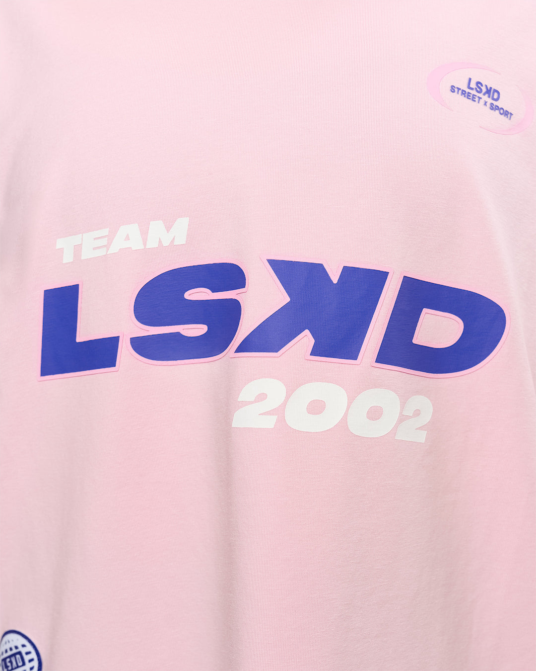 Woman wearing League Heavyweight FLXCotton Oversized Tee - Marshmallow-Power Cobalt | Model:Rhiley | Size:XS