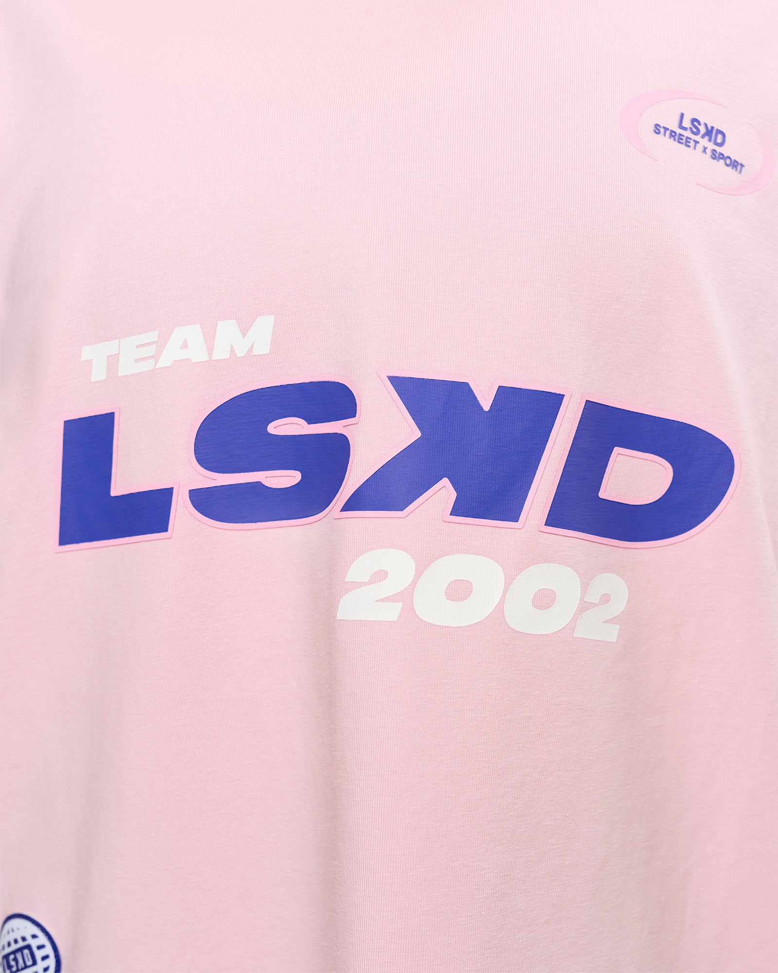 Woman wearing League Heavyweight FLXCotton Oversized Tee - Marshmallow-Power Cobalt | Model:Rhiley | Size:XS