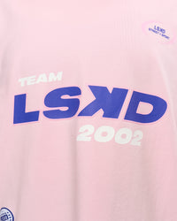 Woman wearing League Heavyweight FLXCotton Oversized Tee - Marshmallow-Power Cobalt | Model:Rhiley | Size:XS