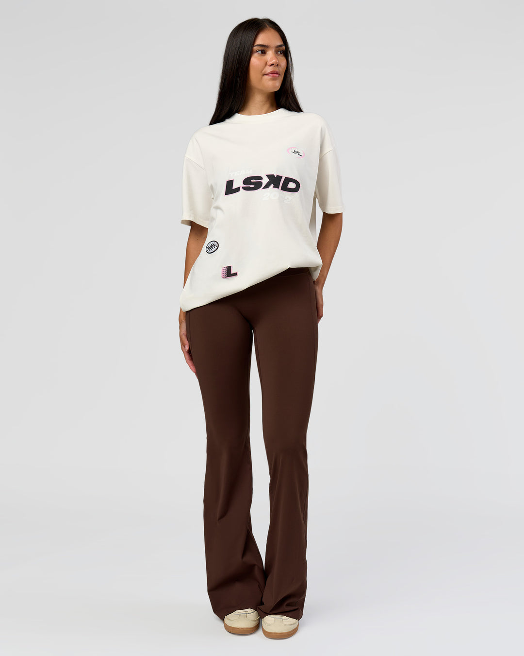 Woman wearing League Heavyweight FLXCotton Oversized Tee - Off White-Ground Coffee | Model:Rhiley | Size:XS