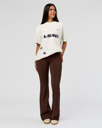 Woman wearing League Heavyweight FLXCotton Oversized Tee - Off White-Ground Coffee | Model:Rhiley | Size:XS