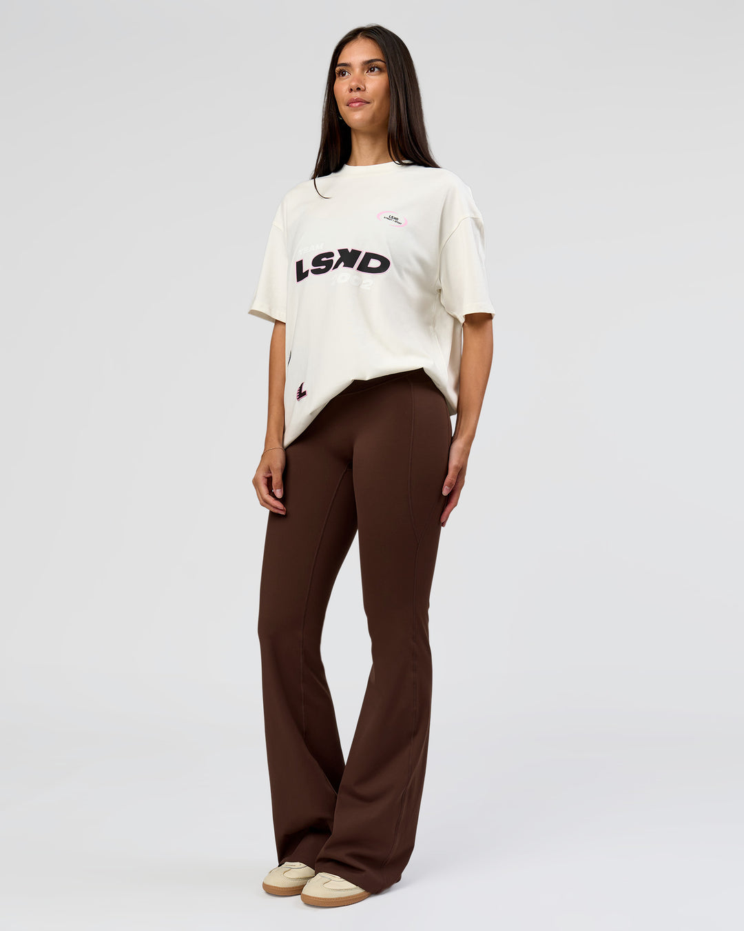 Woman wearing League Heavyweight FLXCotton Oversized Tee - Off White-Ground Coffee | Model:Rhiley | Size:XS