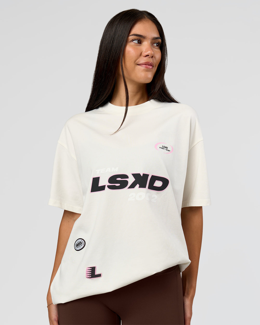 Woman wearing League Heavyweight FLXCotton Oversized Tee - Off White-Ground Coffee | Model:Rhiley | Size:XS