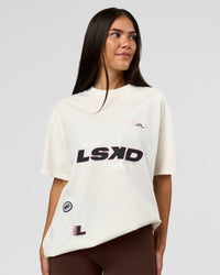 Woman wearing League Heavyweight FLXCotton Oversized Tee - Off White-Ground Coffee | Model:Rhiley | Size:XS