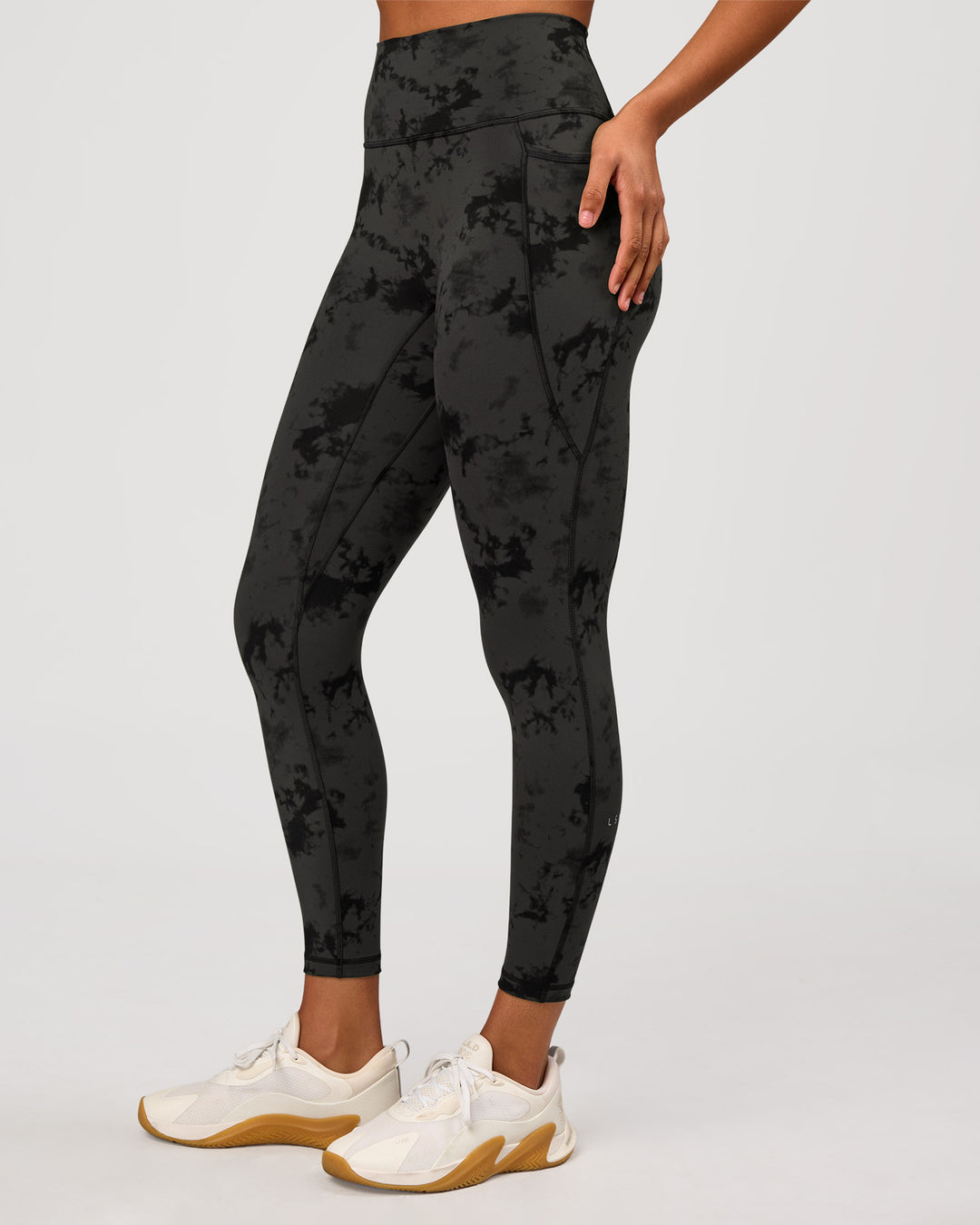 Woman wearing Fusion Ultra High-Rise 7/8 Legging Pockets - Obsidian/Black Tye Dye | Model:Rosie | Size:XS - view 1