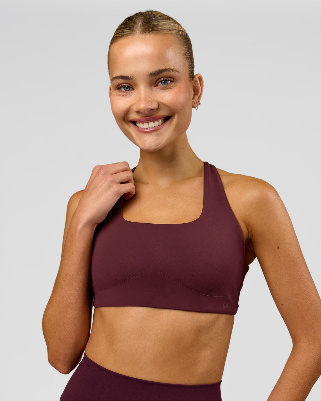 Woman wearing Aspire Sports Bra - Cherry Lacquer | Model:Taneisha | Size:XS - view 2