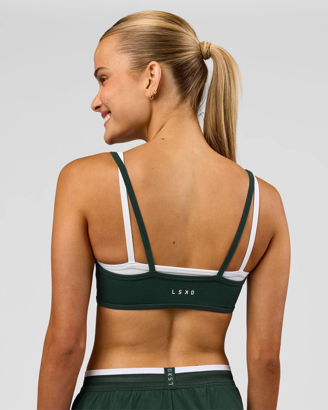 Woman wearing Balance Sports Bra - Midnight Green-White | Model:Taneisha | Size:XS - view 2