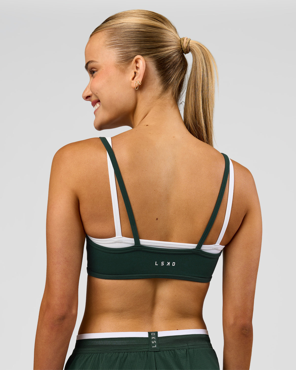 Woman wearing Balance Sports Bra - Midnight Green-White | Model:Taneisha | Size:XS