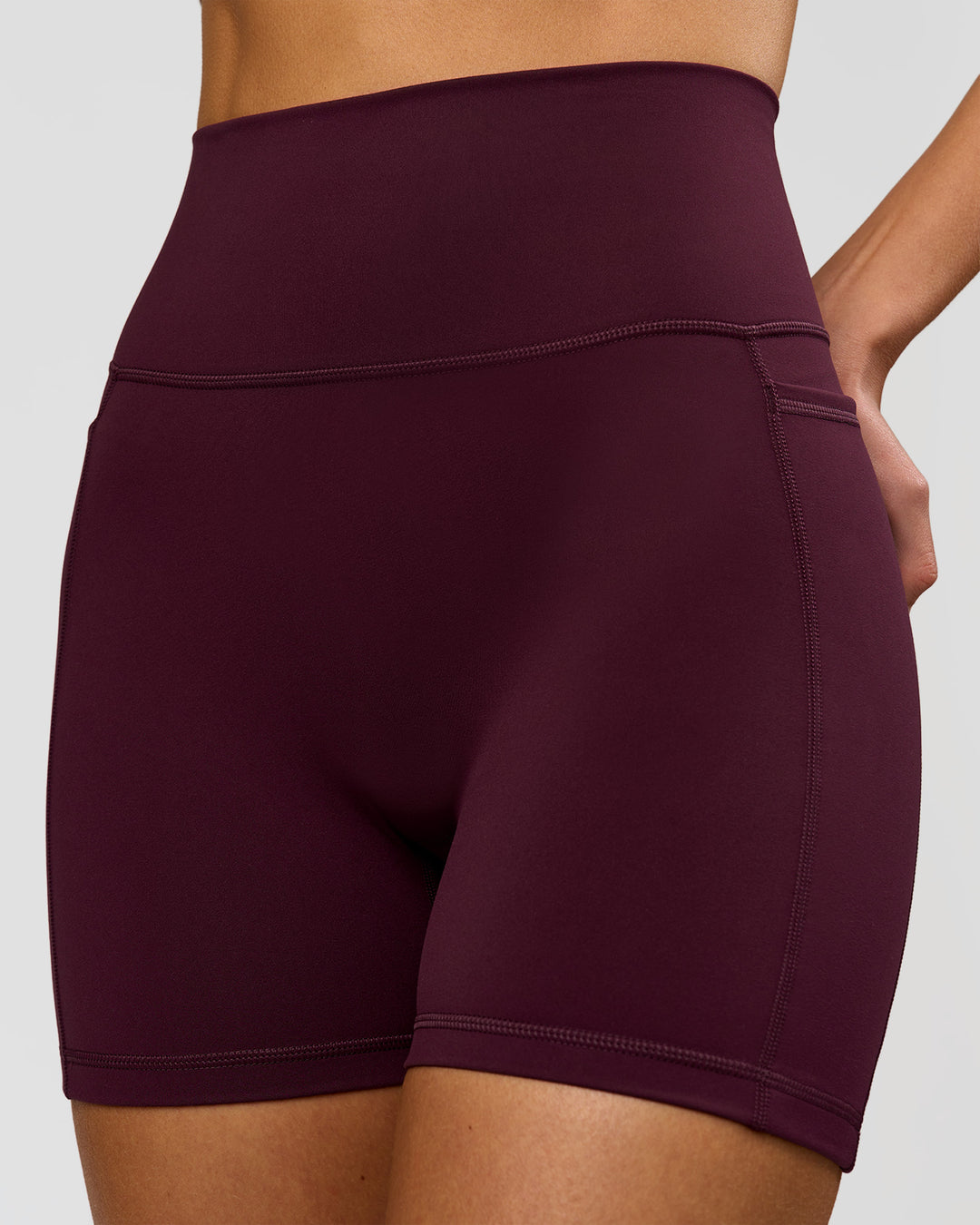 Woman wearing Fusion V-Contour Ultra High-Rise 4" Short Pockets - Cherry Lacquer | Model:Taneisha | Size:XS - view 2