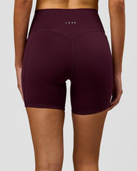 Woman wearing Fusion V-Contour Ultra High-Rise 6" Short Pockets - Cherry Lacquer | Model:Taneisha | Size:XS | Thumbnail Index: 0