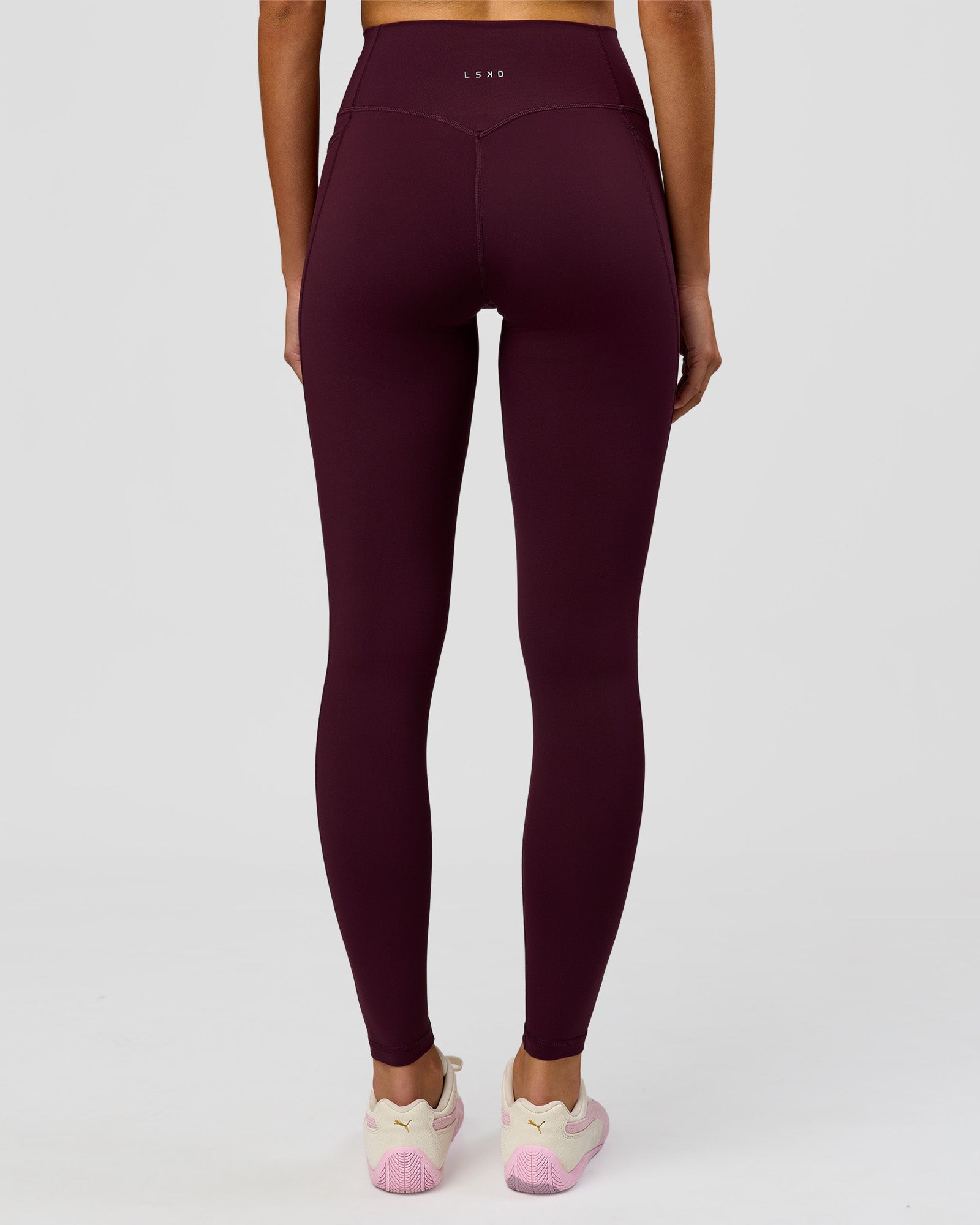 Woman wearing Fusion V-Contour Ultra High-Rise Full Length Legging Pockets - Cherry Lacquer | Model:Taneisha | Size:XS