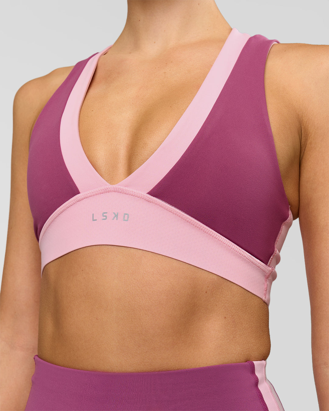 Woman wearing Stamina Layered Sports Bra - Boysenberry-Pink Rose | Model:Taneisha | Size:XS - view 2