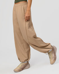 Woman wearing Stitch Up Track Pant - Warm Smoke | Model:Taneisha | Size:XS | Thumbnail Index: 0