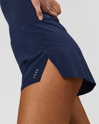 Woman wearing Tia-Clair Toomey-Orr Legacy 3" Run One-Piece - Future Navy | Model:Taneisha | Size:XS | Thumbnail Index: 14