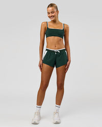 Woman wearing Trackline Accelerate 3" Mid Rise Running Short - Midnight Green-White | Model:Taneisha | Size:XS | Thumbnail Index: 3
