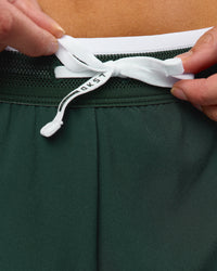 Woman wearing Trackline Accelerate 3" Mid Rise Running Short - Midnight Green-White | Model:Taneisha | Size:XS | Thumbnail Index: 5