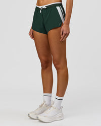 Woman wearing Trackline Accelerate 3" Mid Rise Running Short - Midnight Green-White | Model:Taneisha | Size:XS | Thumbnail Index: 9