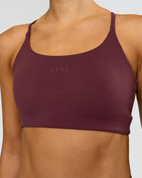 Woman wearing Twist Sports Bra - Cherry Lacquer | Model:Taneisha | Size:XS | Thumbnail Index: 1