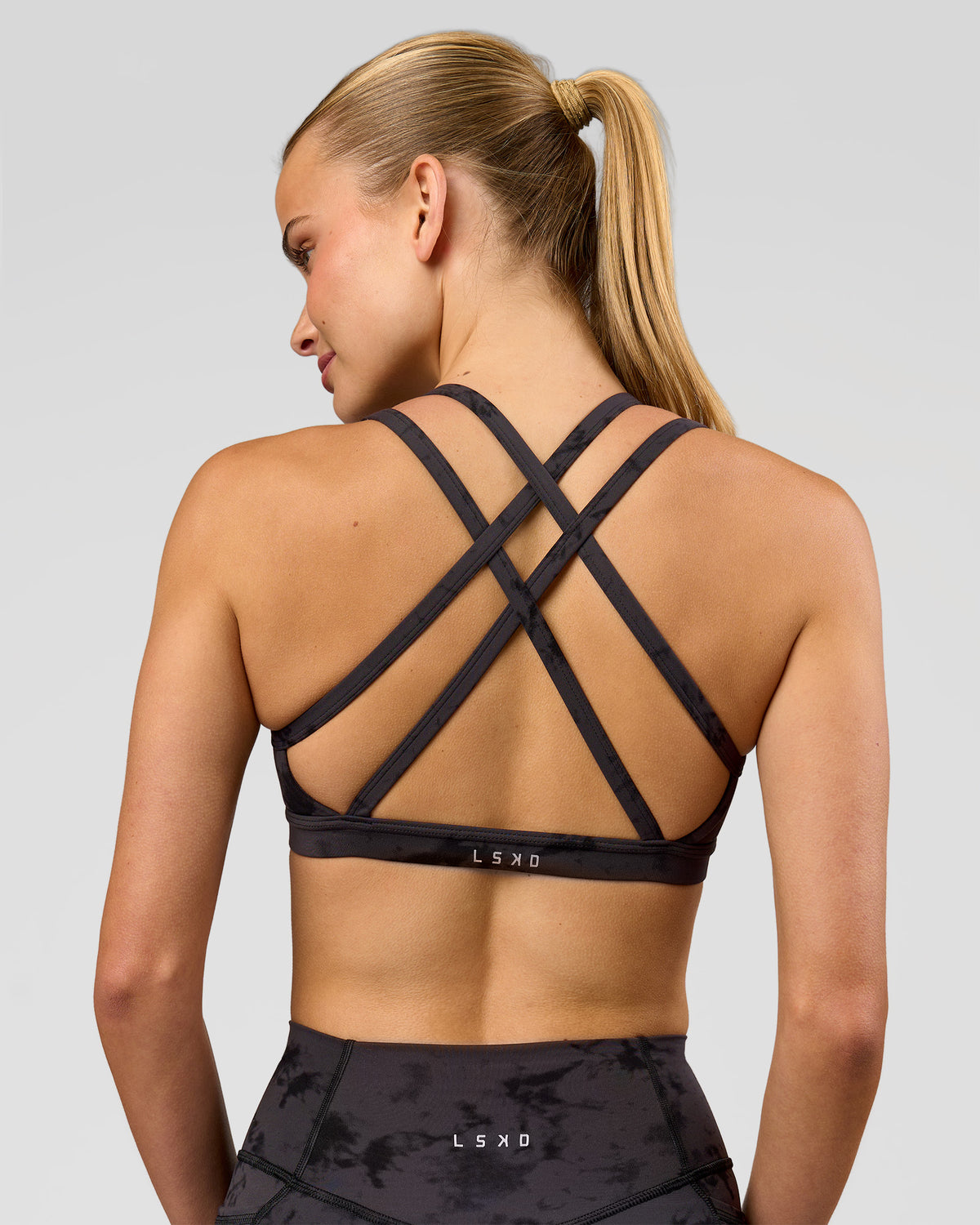 Woman wearing Velocity Sports Bra - Black Tie Dye | Model:Taneisha | Size:XS