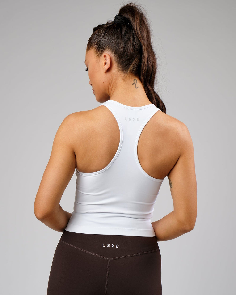 Woman wearing Flow Performance Tank - White