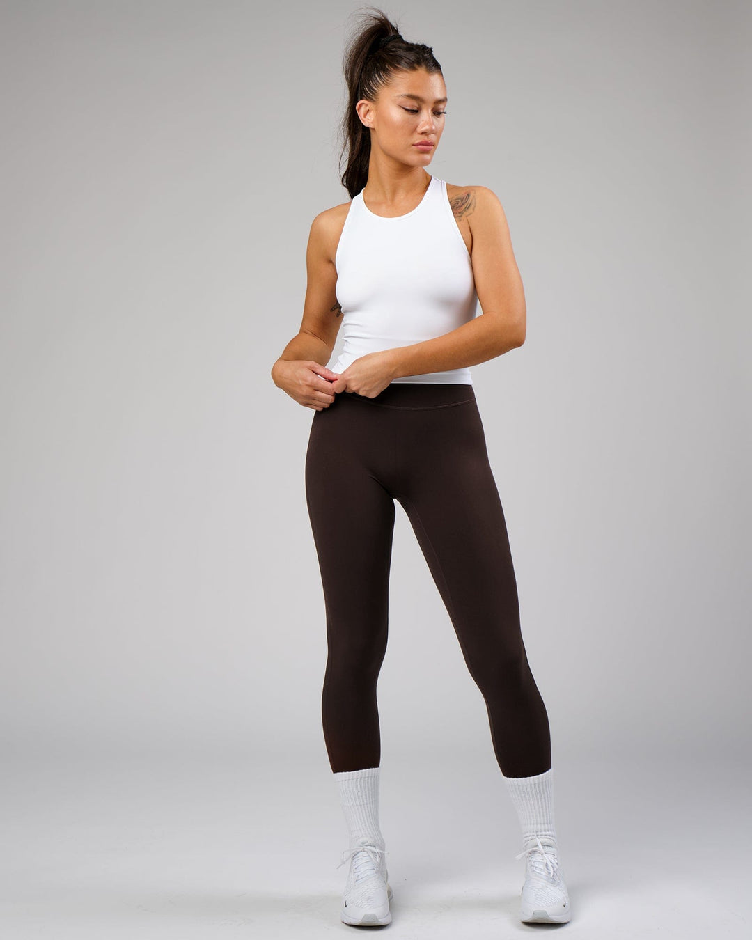 Woman wearing Flow Performance Tank - White