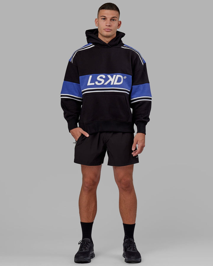 Man wearing Unisex A-Team Hoodie Oversize - Black-Power Cobalt