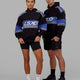 Man and Woman wearing Unisex A-Team Hoodie Oversize - Black-Power Cobalt