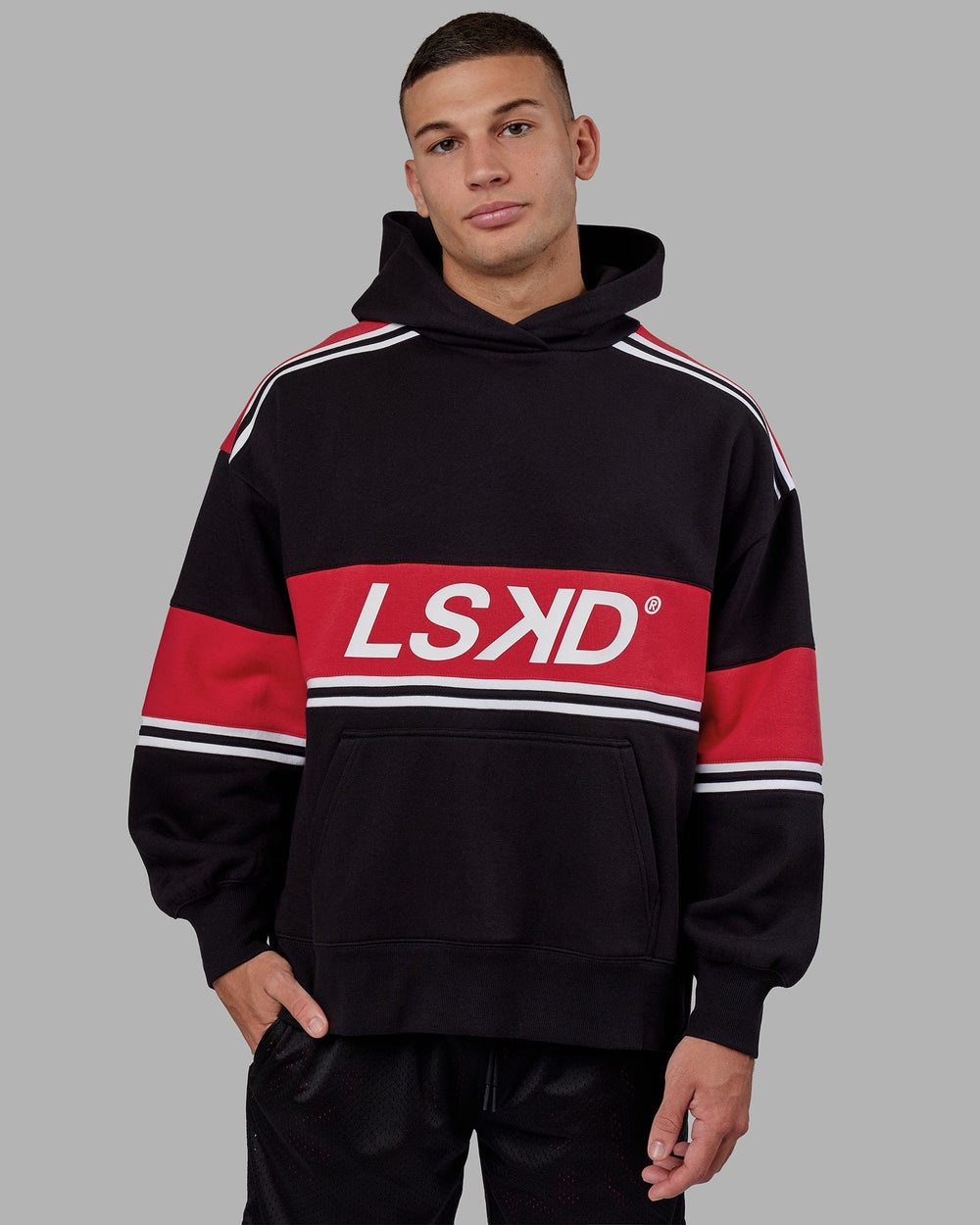Man wearing Unisex A-Team Hoodie Oversize - Black-Scarlet