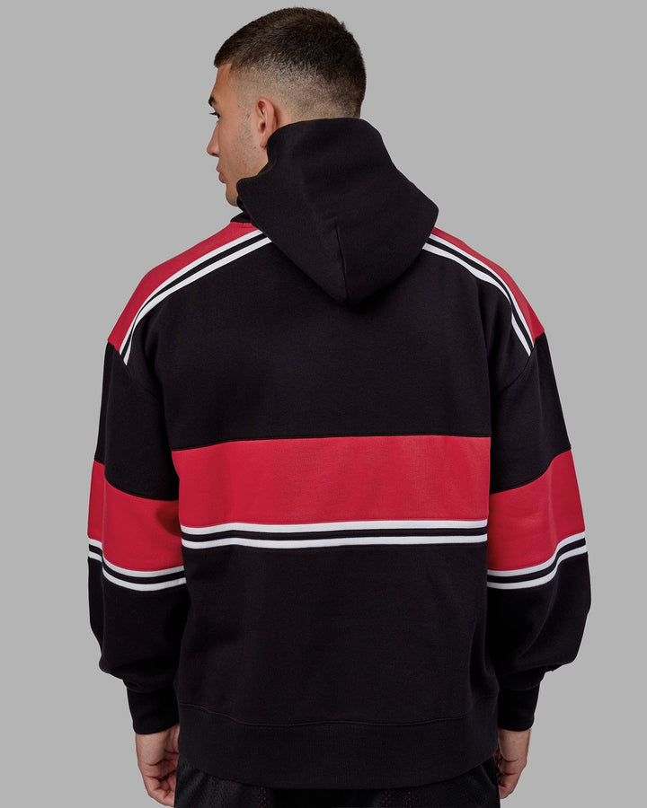 Man wearing Unisex A-Team Hoodie Oversize - Black-Scarlet