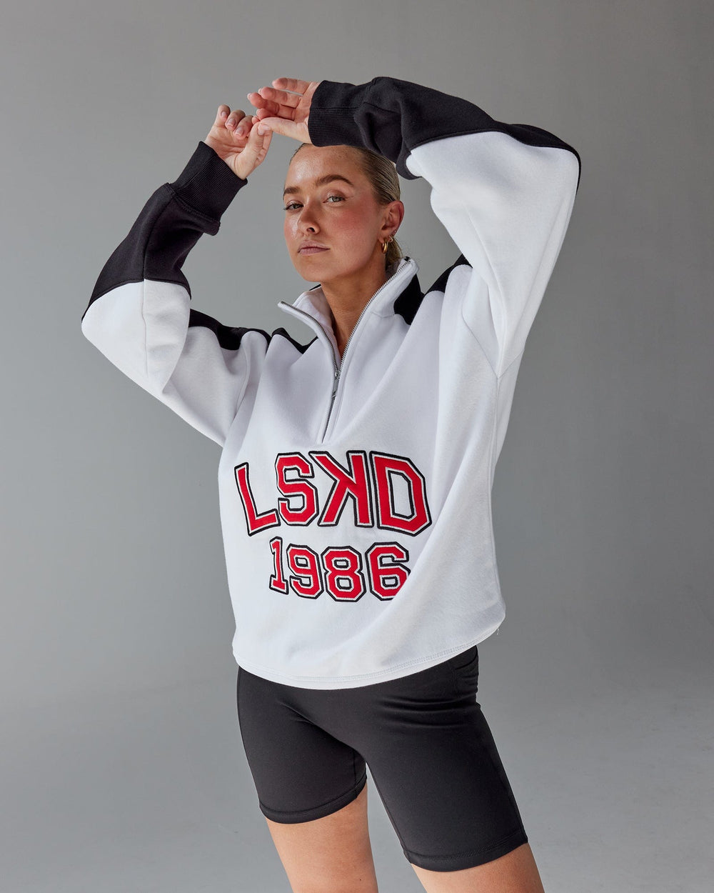 Woman wearing Unisex Alumni 1/4 Zip Sweater Oversize - White-Scarlet