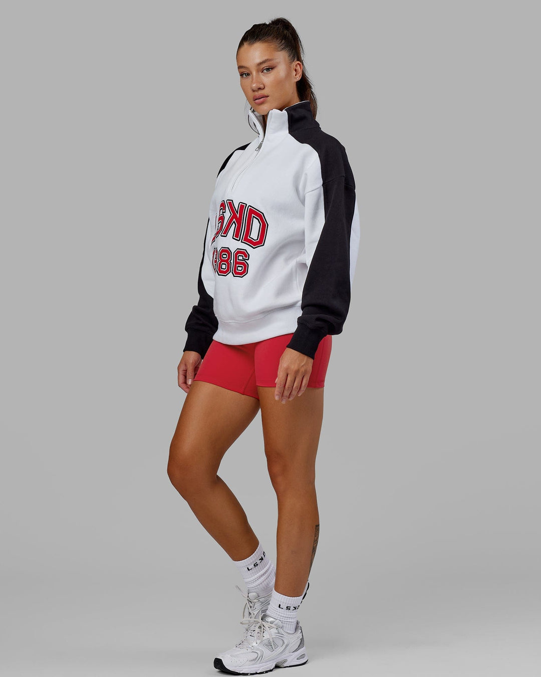 Woman wearing Unisex Alumni 1/4 Zip Sweater Oversize - White-Scarlet