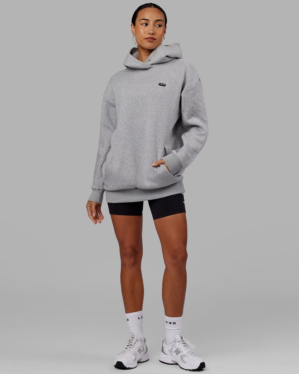 Woman wearing Unisex Capsule Hoodie Oversize - Lt Grey Marl