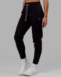 Woman wearing Unisex Capsule Track Pant - Black