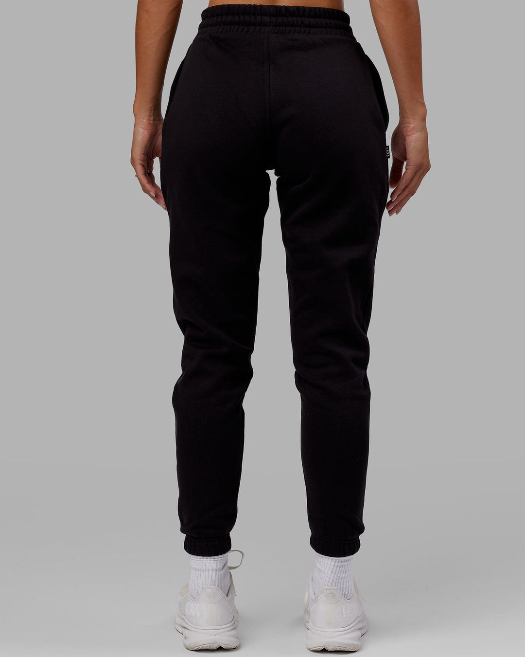 Woman wearing Unisex Capsule Track Pant - Black