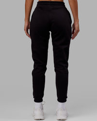 Woman wearing Unisex Capsule Track Pant - Black